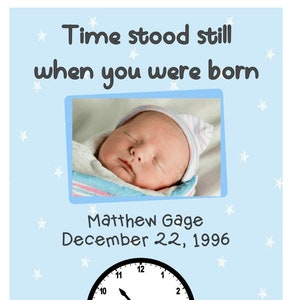 May include: A blue and white baby announcement card with a photo of a newborn baby sleeping. The card says "Time stood still when you were born" and "Matthew Gage December 22, 1996". A clock with the hands set at 10:45 is in the bottom right corner.