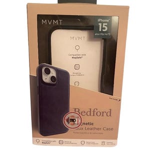 May include: A black leather phone case with a raised lip for camera protection. The case is compatible with MagSafe and is designed for the iPhone 15. The packaging shows the case in a dark blue colour.