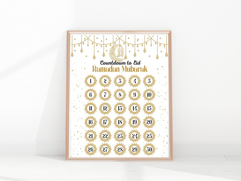 May include: A printable countdown calendar for Ramadan with gold and white accents. The calendar features a crescent moon and lantern design and the text "Countdown to Eid Ramadan Mubarak".