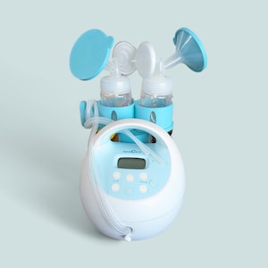 May include: A blue and white electric breast pump with two bottles and a digital display. The pump has a control panel with buttons for cycle, speed, and vacuum.