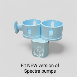 May include: A light blue Spectra pump accessory with two circular holders and a handle. The base has a logo and the text "Fit NEW version of Spectra pumps". The accessory is designed to hold Spectra pumps.