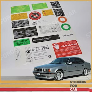 May include: A silver BMW E34 car with a collection of stickers. The stickers display safety information, warnings, and the text "STICKERS FOR CAR". The stickers are in various colours, including green, red, and black.