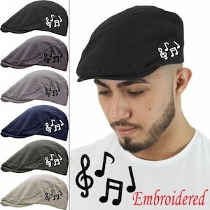May include: Six different coloured cotton twill flat caps with an embroidered music note design. The caps are all the same style and have a curved brim. The design features a treble clef and two musical notes. The text "Embroidered" is visible in the bottom right corner of the image.