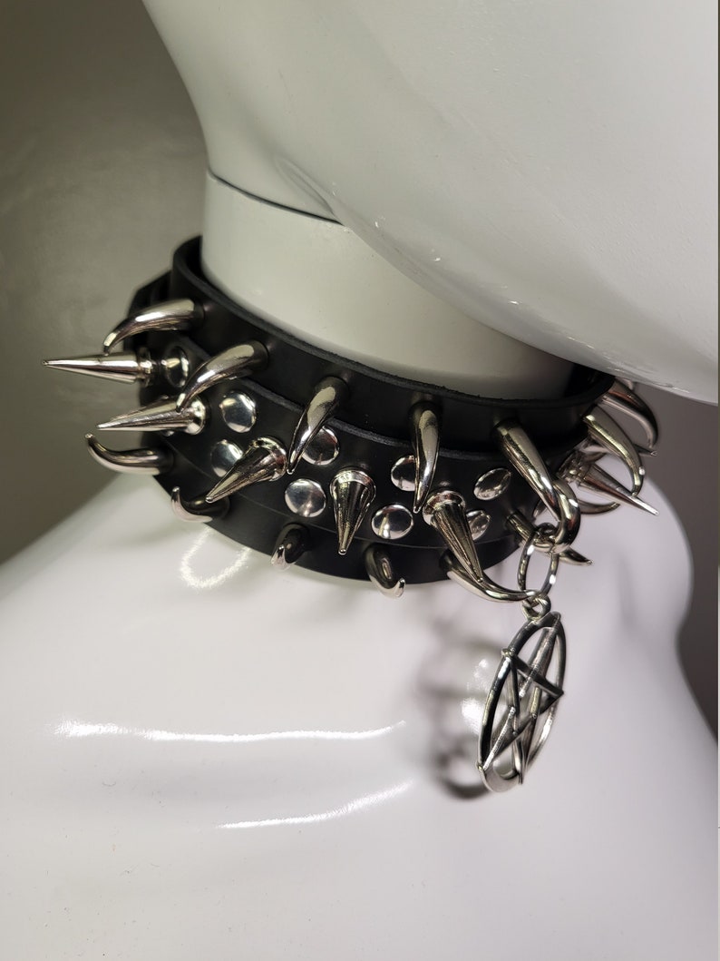 May include: A black leather choker with silver spikes and a pentagram charm.