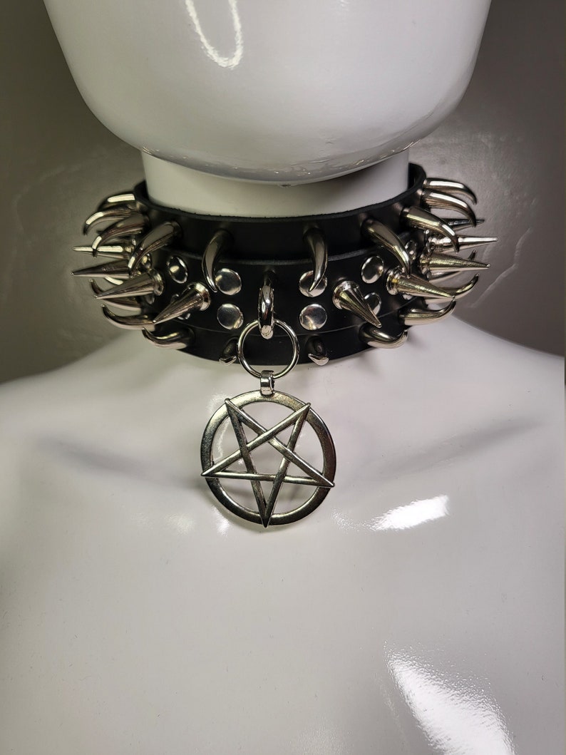 May include: A black leather choker with silver spikes and a pentagram pendant.