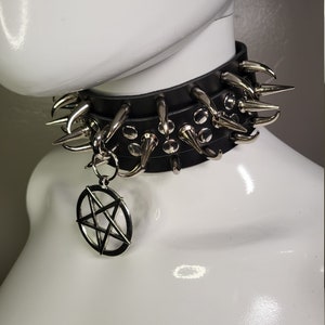 May include: A black leather choker with silver spikes and a pentagram pendant.
