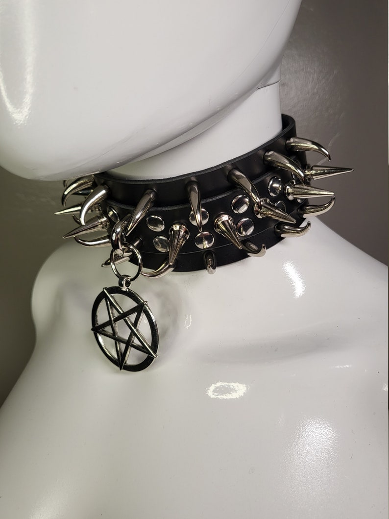 May include: A black leather choker with silver spikes and a pentagram pendant.