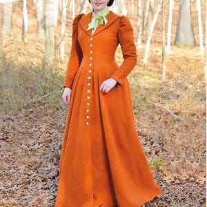 Puede incluir: Un abrigo largo naranja con botones decorativos y cuello alto. Se lleva con un sombrero a juego y una bufanda verde. El texto en la parte inferior dice: "Listing is for sewing pattern only."