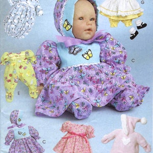 Könnte beinhalten: Bild eines Schnittmusters für Babypuppenkleidung. Das Muster enthält mehrere Outfits: ein lila Kleid und eine Haube mit Schmetterlingsmuster, ein gelbes Outfit, ein rosa Kleid und einen rosa Kapuzenoverall. Der Text "Listing is for sewing pattern only" steht unten.