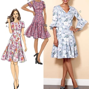 May include: Sewing pattern for a dress with three different styles. The dress has a fitted bodice and a flared skirt. The first style has short sleeves and a round neckline. The second style has cold shoulder sleeves and a round neckline. The third style has long sleeves with bell cuffs and a V-neckline. The pattern is labeled B6514.