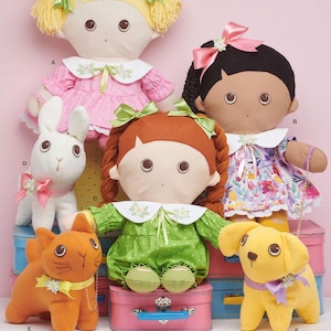 May include: Sewing pattern for making 18-inch dolls and their accessories. The pattern includes instructions for making a blonde doll, a brown-haired doll, a doll with black hair, a bunny, a cat, and a puppy.