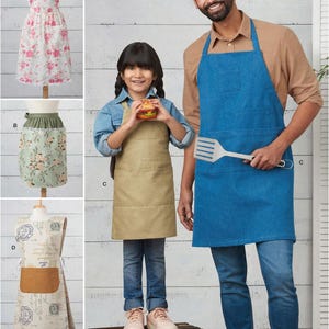 May include: Sewing pattern for three aprons: a blue denim apron, a beige canvas apron, and a floral print apron. The aprons have pockets and adjustable straps. The pattern includes instructions for making all three aprons.
