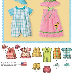 May include: Sewing pattern for a baby's outfit. The pattern includes a dress, a romper, and a hat. The dress is pink with a green trim and a flower design. The romper is blue and white plaid. The hat is blue. The pattern is designed and printed in the USA.