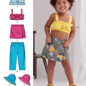 May include: Sewing pattern for a girl's outfit with a blue gingham top, a yellow top with a bow, a pink polka dot skirt, a floral skirt, blue pants, and two hats. The pattern is designed and printed in the USA.