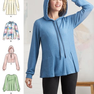 May include: A sewing pattern for a hooded sweatshirt with a pleated hem. The pattern includes four different styles: a white sweatshirt, a tie-dye sweatshirt, a pink cropped sweatshirt, and a green sweatshirt with a round neckline.