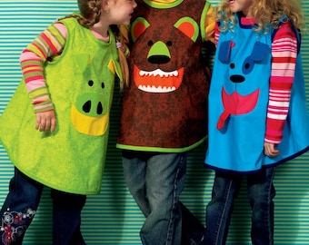 May include: Three sleeveless tabards featuring animal faces: a green pig, a brown bear, and a blue dog. Each tabard has a distinct animal design on the front. The text at the bottom states: Listing is for sewing pattern only.