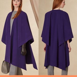 May include: Purple cape sewing pattern with a diagonal hemline. The pattern is shown on a model wearing the cape.