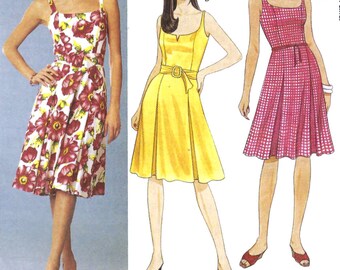 May include: Sewing pattern for a sleeveless dress with a square neckline and a fitted bodice. The pattern includes three variations: a floral print dress, a yellow dress with a belt, and a red and white gingham dress.