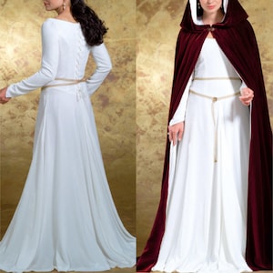 May include: A sewing pattern for a medieval-style gown with a long, flowing skirt and long sleeves. The pattern includes a separate cape with a hood. The gown is white and the cape is burgundy.