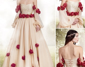 May include: A beige strapless gown featuring a corset bodice, long sheer sleeves, and a full-length skirt adorned with deep red fabric roses. The garment includes a lace-up back closure and a matching headpiece. The text states: Designed and printed in USA. Listing is for sewing pattern only.