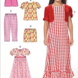 May include: Sewing pattern for a girl's dress, top, pants, and shorts. The dress has a red and white heart print with a red velvet bolero. The top has a plaid print and a matching bolero. The pants and shorts have a pink and white plaid print. The pattern number is M7277.