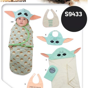 May include: A sewing pattern for a baby's hooded towel, a swaddle blanket, and three bibs. The pattern features a character from the Star Wars: The Mandalorian TV series. The pattern number is S9433.