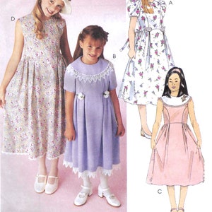 May include: Sewing pattern for three girls' dresses. The dresses are in floral print, lavender, and pink. The pattern includes a hat.