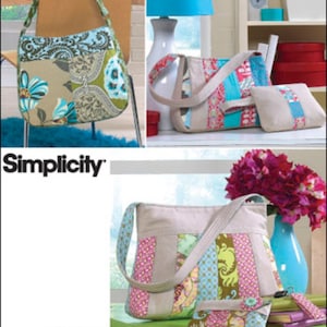 May include: A sewing pattern for three different patchwork bags. The bags are made with a variety of fabrics in shades of blue, green, pink, and brown. The pattern is called "Simplicity" and is designed by Autumn Hall.
