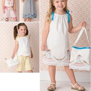 May include: A sewing pattern for a girl's dress and matching bag. The dress is white with a floral design and a lace trim. The bag is white with a blue trim and a floral design. The pattern is from Drake & Ferris.