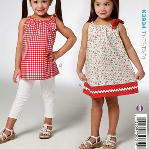 May include: Sewing pattern for a sleeveless dress with a gathered neckline and a ruffled hem. The dress is shown in two different fabrics, one with a red and white gingham pattern and the other with a floral print. The pattern is for sizes T1-T2-T3-T4.