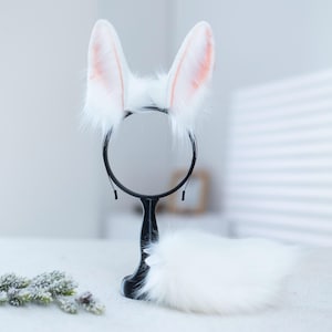 May include: White fluffy bunny ears headband with a black headband and a white fluffy tail.