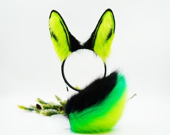 May include: A black headband with green and black faux fur ears and a matching green and black faux fur tail.
