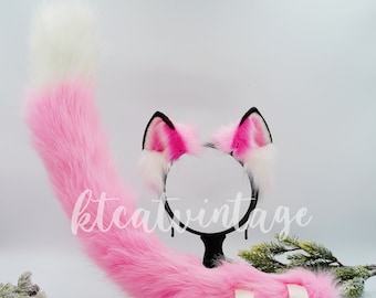 May include: Pink fluffy cat tail and a headband with pink cat ears. The headband has a black elastic band and the ears are trimmed with white fur.