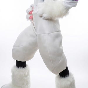 May include: White bunny costume with fluffy paws and leg warmers. The costume features a white jumpsuit with padded knees and black socks. The paws have pink accents. A fun and whimsical outfit for cosplay or themed events.