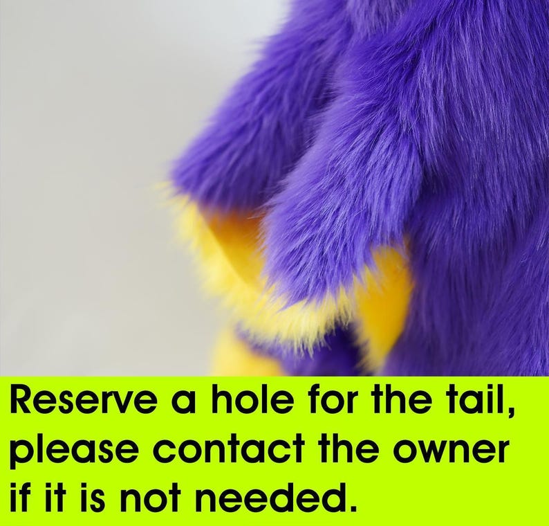 a purple and yellow stuffed animal with a quote on it