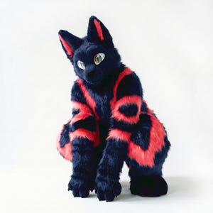 May include: A full-body animal costume featuring thick, dark navy blue faux fur with vibrant, horizontal neon pink stripes across the torso, arms, and legs. The headpiece has large, pointed ears with pink inner accents and large, expressive eyes.