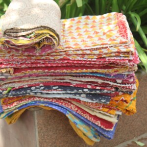 May include: A stack of colourful fabric scraps, some with patterns, some with solid colours. The fabric is folded neatly and appears to be made of cotton.