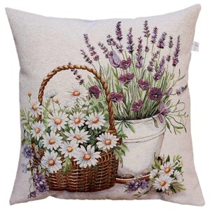 May include: Cushion with a floral tapestry design. The image shows a basket of daisies and a pot of lavender. The color scheme includes white, purple, green, and brown. The cushion is a square shape.