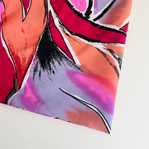 May include: Abstract floral print fabric in shades of pink, orange, purple, and black. The fabric has a soft, flowing texture.