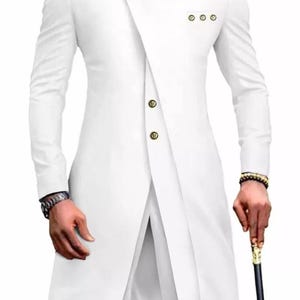 May include: A white long-sleeved suit with a mandarin collar and gold buttons. The suit has a unique asymmetrical design with a long, flowing front panel.