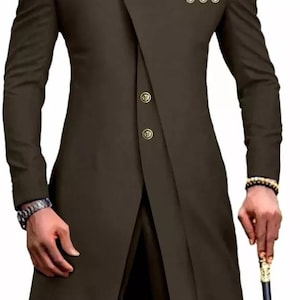 May include: A long-sleeved brown suit jacket with a mandarin collar and gold buttons. The jacket has a unique asymmetrical design with a long, flowing front panel.