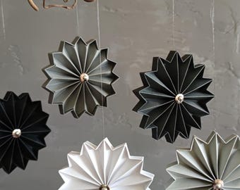 Paper pleated pendants in black/white/grey tones with a silver bead, subtle accents for a stylish room design