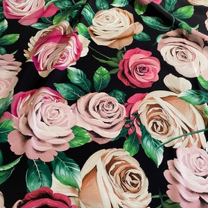 May include: Black fabric with a repeating pattern of pink, white, and beige roses with green leaves.