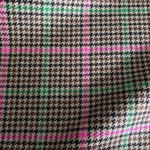 May include: A brown, black, and green houndstooth fabric with pink and green stripes.