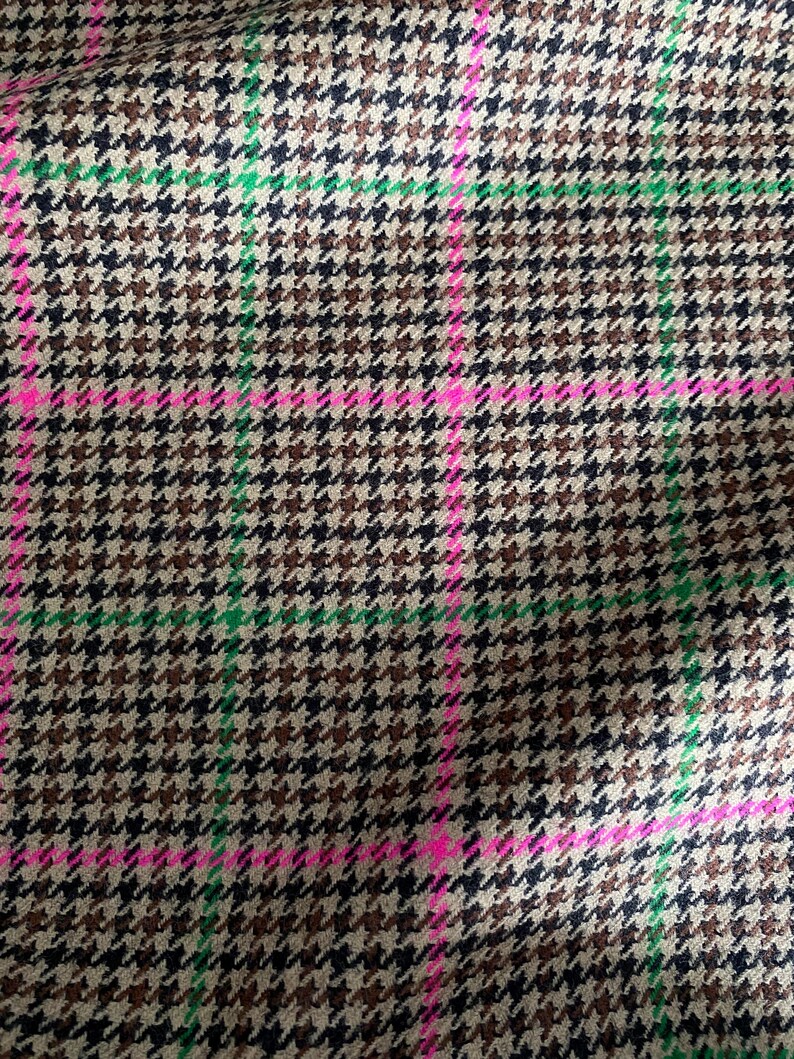 May include: A brown, black, and green houndstooth fabric with pink and green stripes.