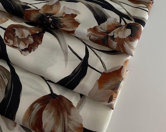 Exclusive Italian designer silk twill fabric, in famous designer style, premium quality. Cream-colored background.