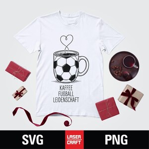 May include: White t-shirt featuring a black and white soccer ball design on a coffee mug, with steam forming a heart shape. The text "KAFFEE FUSSBALL LEIDENSCHAFT" is below the mug. Several wrapped gifts and a tray with a drink are also visible.