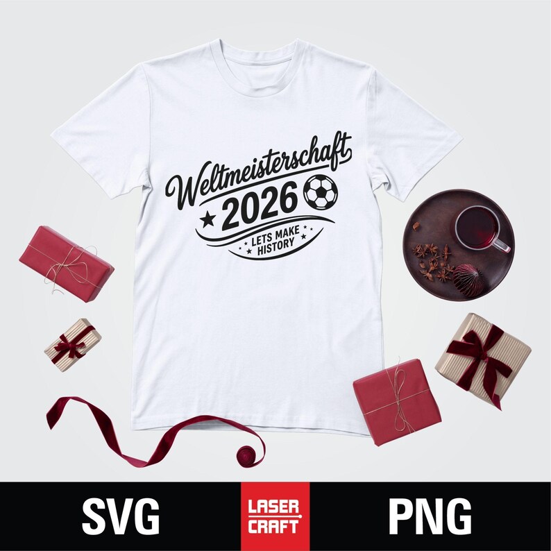 May include: White t-shirt with the text "Weltmeisterschaft 2026" and a soccer ball graphic. The phrase "Lets Make History" is also included. The shirt is surrounded by wrapped gifts and a decorative plate.