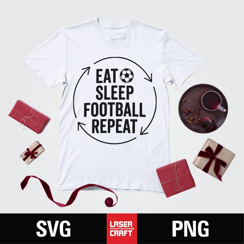 May include: White t-shirt with the text "EAT SLEEP FOOTBALL REPEAT" in black, with a soccer ball graphic. The shirt is surrounded by red wrapped gifts, a dark brown plate with a cup, and a red ribbon.