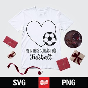 May include: White t-shirt with a black heart and soccer ball graphic. Text reads "MEIN HERZ SCHL&Auml;GT F&Uuml;R Fu&szlig;ball". The shirt is surrounded by wrapped gifts and a decorative plate. SVG and PNG file formats are displayed.